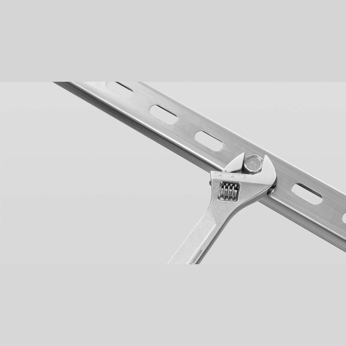 Adjustable wrench from the Xiaomi Mijia Tool Kit gripping a metal bar, showing the chrome-plated jaw