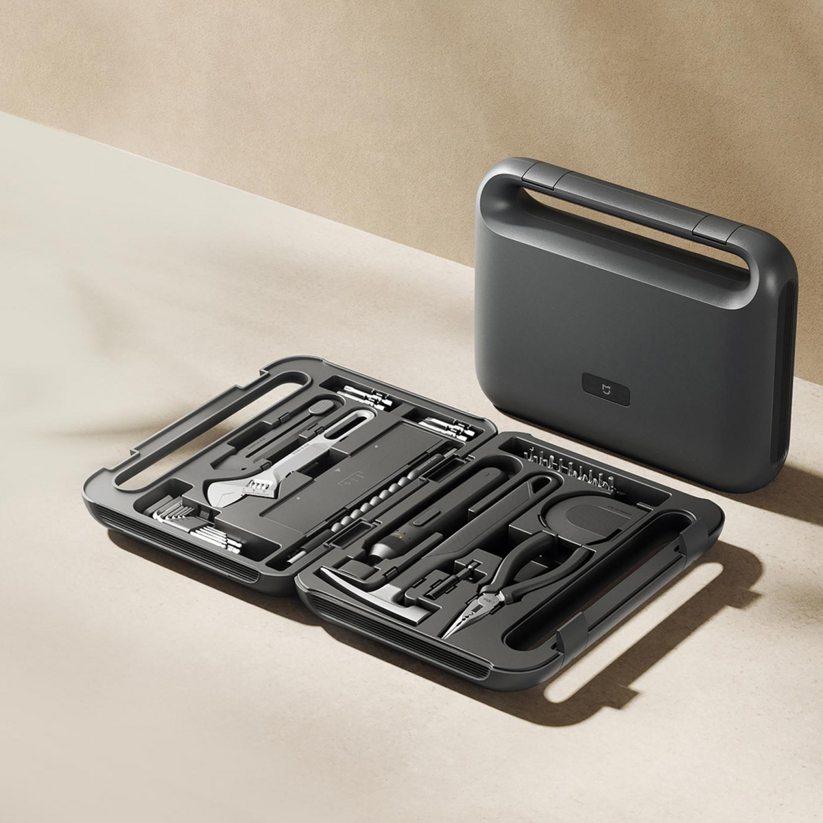 Xiaomi Mijia Tool Kit open on a table next to the closed case, showing the tools in place