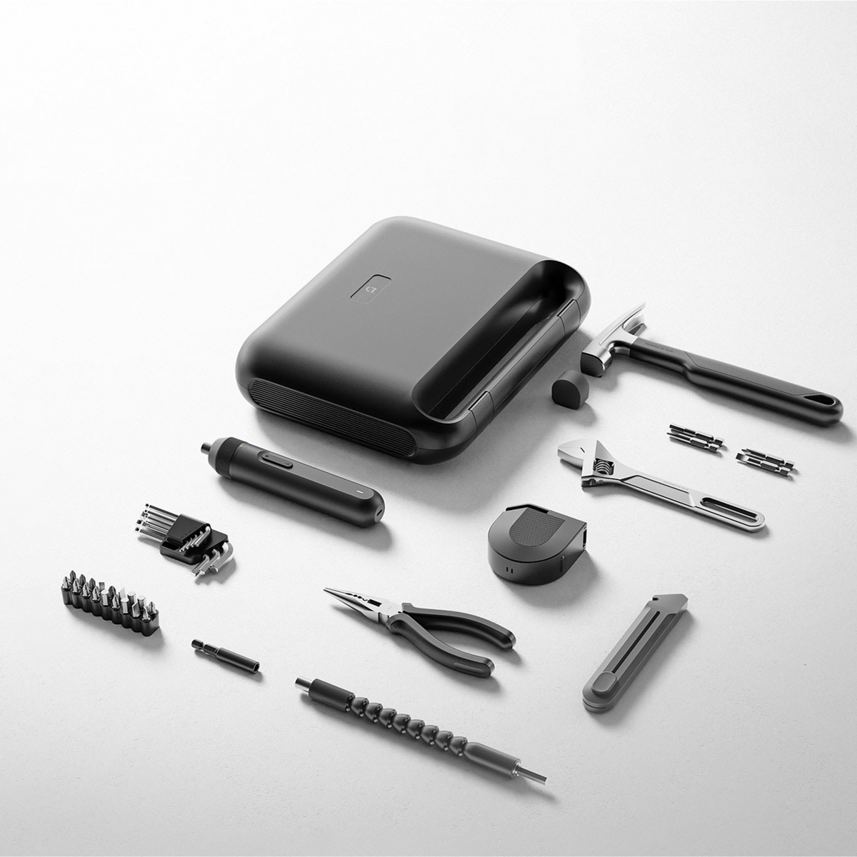 Xiaomi Mijia Tool Kit, the closed storage case with the electric screwdriver, bits, hammer, wrench, pliers and tape measure laid out beside it