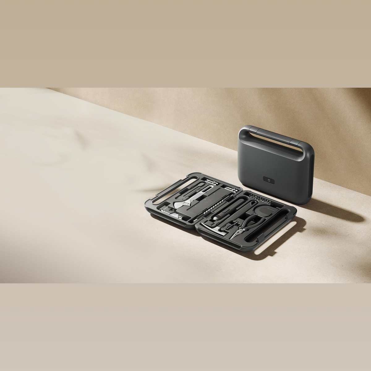 Xiaomi Mijia Tool Kit open on a table next to the closed case, showing the tools in place